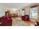 Formal living room featuring hardwood floors, large windows, neutral walls, and a dining area for entertaining guests at 2175 Fisher Ne Trl, Atlanta, GA 30345
