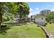 Expansive backyard features brick retaining wall, lawn, patio, and mature trees at 2315 Tuxedo Se Dr, Marietta, GA 30067