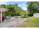 Spacious backyard with mature trees, patio with dining set, and storage shed at 2315 Tuxedo Se Dr, Marietta, GA 30067