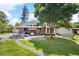 Large backyard with patio, seating, barbecue, and mature tree providing shade at 2315 Tuxedo Se Dr, Marietta, GA 30067