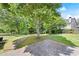 Lush backyard with mature trees, brick walkway and ample green space at 2315 Tuxedo Se Dr, Marietta, GA 30067