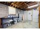 Unfinished basement area features concrete walls, open ceiling, and metal shelving for storage at 2315 Tuxedo Se Dr, Marietta, GA 30067