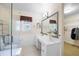 Bathroom vanity with a mirror, and shower with glass door next to a functional walk-in closet at 2315 Tuxedo Se Dr, Marietta, GA 30067
