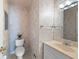 Cozy bathroom featuring a decorative wall, standard toilet and sink, and large mirror at 2315 Tuxedo Se Dr, Marietta, GA 30067