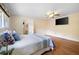 A bright bedroom featuring hardwood floors, a ceiling fan, a window and a bed with stylish bedding at 2315 Tuxedo Se Dr, Marietta, GA 30067