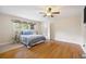 Comfortable bedroom featuring hardwood floors, a ceiling fan, a window and a bed with stylish bedding at 2315 Tuxedo Se Dr, Marietta, GA 30067