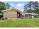 Single story home with stone details, a red door, brick, and well maintained lawn, with a carport at 2315 Tuxedo Se Dr, Marietta, GA 30067