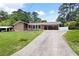 Well-maintained ranch home with inviting front lawn, mature landscaping, and paved driveway at 2315 Tuxedo Se Dr, Marietta, GA 30067