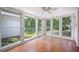 Sunroom with hardwood floors and lots of windows with view to the yard at 2315 Tuxedo Se Dr, Marietta, GA 30067