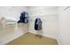 Functional walk-in closet with carpet floors and wire rack shelving for organizing clothes and accessories at 2315 Tuxedo Se Dr, Marietta, GA 30067
