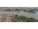 Scenic aerial view of a lake and forested areas, showcasing the natural landscape and waterfront at 2701 Montie Ct, Lithia Springs, GA 30122