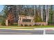 Stone-accented Fairhaven community entrance, complete with professional landscaping and manicured lawns at 2701 Montie Ct, Lithia Springs, GA 30122