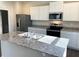 Well-lit kitchen showcases granite counters, stainless appliances, and modern white cabinetry at 2701 Montie Ct, Lithia Springs, GA 30122