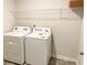 Convenient laundry room includes a washing machine, dryer, and a storage shelf above at 2701 Montie Ct, Lithia Springs, GA 30122