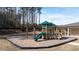 Community playground with slide, swings, and climbing area surrounded by a mulch bed at 2701 Montie Ct, Lithia Springs, GA 30122