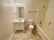 Bathroom with tile floors features a vanity and tub with shower at 6026 Woodcreek Dr, Woodstock, GA 30188