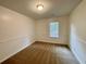 Bedroom features neutral walls and carpet, with a window providing natural light at 6026 Woodcreek Dr, Woodstock, GA 30188