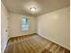 A cozy bedroom features neutral carpet, walls, and a window for natural light at 6026 Woodcreek Dr, Woodstock, GA 30188