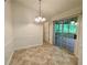 Dining area with stylish lighting and sliding doors to the screened-in porch, ideal for indoor/outdoor entertaining at 6026 Woodcreek Dr, Woodstock, GA 30188