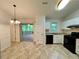 Eat-in kitchen featuring white cabinets, modern appliances, and a sliding door that leads to a screened in porch at 6026 Woodcreek Dr, Woodstock, GA 30188