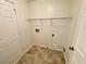 Functional laundry area with tile flooring and plenty of room for laundry appliances at 6026 Woodcreek Dr, Woodstock, GA 30188