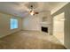 Spacious living room with neutral colored carpet and fireplace at 6026 Woodcreek Dr, Woodstock, GA 30188