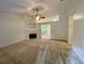 Bright living room featuring a fireplace and neutral carpet, providing a cozy and inviting atmosphere at 6026 Woodcreek Dr, Woodstock, GA 30188