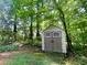 Outdoor shed amongst mature trees in a lush green backyard at 6026 Woodcreek Dr, Woodstock, GA 30188