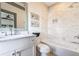 Elegant bathroom with marble tile, white cabinets, framed mirror, and modern fixtures at 661 Auburn Ne Ave # 10, Atlanta, GA 30312