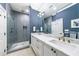Modern bathroom featuring double vanities, a glass-enclosed shower with gray tiling, and upscale finishes at 661 Auburn Ne Ave # 10, Atlanta, GA 30312