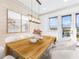 Elegant dining room features a wood table, stylish seating, modern art, and outside view at 661 Auburn Ne Ave # 10, Atlanta, GA 30312