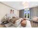 Beautiful main bedroom with a large bed, a seating area, and a balcony with a community view at 661 Auburn Ne Ave # 10, Atlanta, GA 30312