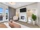 Well-decorated bedroom featuring a chair, fireplace, and balcony with curtains on the windows at 661 Auburn Ne Ave # 10, Atlanta, GA 30312