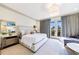 Serene main bedroom with neutral tones, a comfortable bed, and access to a balcony at 661 Auburn Ne Ave # 10, Atlanta, GA 30312