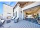 Inviting outdoor patio featuring a fireplace and views into a cozy living area at 661 Auburn Ne Ave # 10, Atlanta, GA 30312