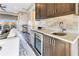 Stylish wet bar featuring granite countertops, a wine fridge, and modern cabinetry in a well-lit living space at 661 Auburn Ne Ave # 10, Atlanta, GA 30312