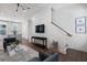 Open concept living room with hardwood floors and a view of the staircase at 1429 Hazy Way # 309, Atlanta, GA 30315