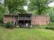Back exterior of brick home with large backyard, screened porch and cluttered patio at 1481 Pine St, Stone Mountain, GA 30087
