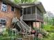 View of the outdoor patio, which includes stairs and overlooks the backyard at 1481 Pine St, Stone Mountain, GA 30087