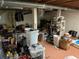 Unfinished basement, cluttered with boxes and storage items at 1481 Pine St, Stone Mountain, GA 30087