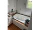 Bathroom featuring a tiled floor, a whirlpool tub, and ample cabinet space at 1481 Pine St, Stone Mountain, GA 30087