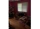 A cluttered bedroom with pink walls and hardwood floors at 1481 Pine St, Stone Mountain, GA 30087