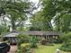 Ranch home exterior with covered parking and mature trees in an established neighborhood at 1481 Pine St, Stone Mountain, GA 30087