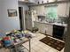 Kitchen features white cabinets, appliances, tile floor and eat in breakfast area at 1481 Pine St, Stone Mountain, GA 30087