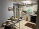Kitchen featuring white cabinets, appliances, tile floor and eat in breakfast area at 1481 Pine St, Stone Mountain, GA 30087