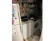 Compact laundry area with stacked washer/dryer and storage shelves at 1481 Pine St, Stone Mountain, GA 30087