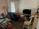 View of living room showing hardwood floors, wall mounted tv and a large window at 1481 Pine St, Stone Mountain, GA 30087