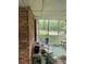 View of the enclosed back porch and green flooring, with white railing overlooking the yard at 1481 Pine St, Stone Mountain, GA 30087