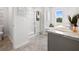 Bright bathroom featuring double sinks, sleek vanity, shower and tub at 2709 Montie Ct, Lithia Springs, GA 30122