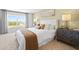 Calm bedroom featuring a large window with natural light, stylish decor and matching night stands at 2709 Montie Ct, Lithia Springs, GA 30122